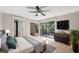 Light-filled main bedroom with access to the lanai, tile flooring, modern furniture, and a ceiling fan at 2722 11Th Ct # 50A, Palm Harbor, FL 34684