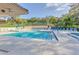 This in-ground pool is surrounded by lounge chairs and lush trees, creating a relaxing and inviting atmosphere at 2722 11Th Ct # 50A, Palm Harbor, FL 34684