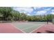 A well-maintained tennis court surrounded by lush trees, offering a great recreational space at 2722 11Th Ct # 50A, Palm Harbor, FL 34684
