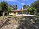 Inviting backyard featuring a screened lanai, lush landscaping, and open patio area, perfect for outdoor entertaining at 2752 Cypress Dr, Clearwater, FL 33763