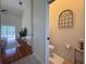 Bright bathroom featuring a toilet and decorative window at 2752 Cypress Dr, Clearwater, FL 33763