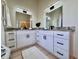 Bathroom with double sinks, granite counters, and modern lighting at 2752 Cypress Dr, Clearwater, FL 33763