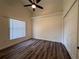 Well lit bedroom features ceiling fan, closet, and wood-look flooring at 2752 Cypress Dr, Clearwater, FL 33763