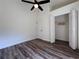 Bright bedroom with wood-look flooring features closet and door to bath at 2752 Cypress Dr, Clearwater, FL 33763