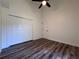 Bedroom boasts a ceiling fan, a closet, and a sleek wood-look floor at 2752 Cypress Dr, Clearwater, FL 33763