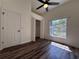 Bedroom with wood-look flooring features a ceiling fan and closet at 2752 Cypress Dr, Clearwater, FL 33763