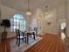 Bright dining area with large windows, high ceilings, stylish light fixtures, and tile flooring at 2752 Cypress Dr, Clearwater, FL 33763