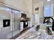 Modern kitchen featuring stainless steel appliances, white cabinets, and elegant countertops at 2752 Cypress Dr, Clearwater, FL 33763