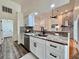 Bright kitchen features white cabinetry, mosaic tile backsplash, and granite countertops with eat-in breakfast bar at 2752 Cypress Dr, Clearwater, FL 33763