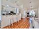 Kitchen view with white cabinetry, a breakfast bar, stainless appliances, and a view of the dining area at 2752 Cypress Dr, Clearwater, FL 33763