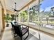 Relaxing screened-in lanai with outdoor furniture and lush greenery at 2752 Cypress Dr, Clearwater, FL 33763