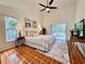 Comfortable main bedroom with ceiling fan, tile floors, and sliding glass doors to a screened porch at 2752 Cypress Dr, Clearwater, FL 33763