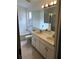 Bathroom featuring double sinks, large mirror, tiled floors, tub and shower at 3314 Pine Top Dr, Valrico, FL 33594