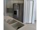 White cabinets, stainless refrigerator and white countertops in this bright kitchen at 3314 Pine Top Dr, Valrico, FL 33594