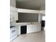 Bright kitchen features white cabinets, laminate countertops, and black appliances at 3314 Pine Top Dr, Valrico, FL 33594