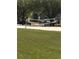 Community sand volleyball court with a net, surrounded by grassy fields and trees at 3314 Pine Top Dr, Valrico, FL 33594