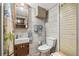 Cozy bathroom featuring grey tile, modern vanity, and updated toilet fixture at 3349 Clydesdale Dr, Holiday, FL 34691