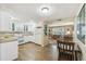 Kitchen is spacious with all-white cabinetry, a dining area and a sunny sitting room at 3349 Clydesdale Dr, Holiday, FL 34691