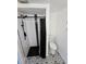 Sleek bathroom with tiled shower, black hardware, and decorative patterned tile flooring at 3532 Overland Dr, Holiday, FL 34691