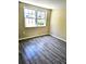 Bedroom showcasing gray, wood-look tile flooring and natural light from the double windows at 3532 Overland Dr, Holiday, FL 34691
