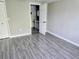 Bedroom with wood-look tile flooring, closet and view to bathroom at 3532 Overland Dr, Holiday, FL 34691