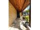 Inviting front porch with stone accent wall, brick paver walkway, and a rich wood plank ceiling at 3532 Overland Dr, Holiday, FL 34691