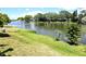 This beautiful property features a canal view from the manicured lawn near the water's edge at 3532 Overland Dr, Holiday, FL 34691