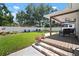 Well-maintained backyard featuring a manicured lawn, patio, and privacy fence at 3906 W De Leon St, Tampa, FL 33609