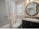 The bathroom features granite counters, a shower-tub, and a decorative mirror at 3906 W De Leon St, Tampa, FL 33609