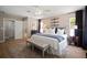 Spacious bedroom with neutral tones, large windows, and a comfortable king-size bed at 3906 W De Leon St, Tampa, FL 33609