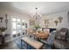 Elegant dining room with a wooden table, chandelier, and stylish seating creating an inviting atmosphere at 3906 W De Leon St, Tampa, FL 33609