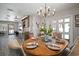Well-lit dining room adjacent to the wet bar, featuring an elegant wooden table and seating for six at 3906 W De Leon St, Tampa, FL 33609