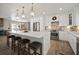 Bright kitchen features stainless steel appliances, white cabinets, pendant lights, and a large island at 3906 W De Leon St, Tampa, FL 33609