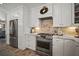 Modern kitchen with stainless steel appliances, marble countertops, and a stylish tile backsplash at 3906 W De Leon St, Tampa, FL 33609