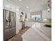 Bright kitchen features stainless steel appliances, white cabinets, and a large island at 3906 W De Leon St, Tampa, FL 33609