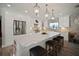 Bright kitchen features stainless steel appliances, white cabinets, pendant lights, and a large island at 3906 W De Leon St, Tampa, FL 33609