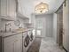 Bright laundry room with modern appliances, custom cabinets, and stylish lighting at 3906 W De Leon St, Tampa, FL 33609