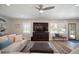 Bright living room with a large flat screen, comfortable seating, and a view of the front entrance at 3906 W De Leon St, Tampa, FL 33609