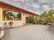 Inviting back porch with sliding glass doors, lush landscaping, and outdoor seating, providing an oasis at 3924 N Ridge Ave, Tampa, FL 33603