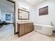 Relaxing bathroom with a soaking tub, a vanity with drawers, and modern finishes at 3924 N Ridge Ave, Tampa, FL 33603