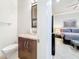 Modern bathroom with granite countertop, updated fixtures, and view into the bedroom at 3924 N Ridge Ave, Tampa, FL 33603