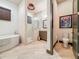 Bathroom featuring a soaking tub, glass shower, and stylish fixtures at 3924 N Ridge Ave, Tampa, FL 33603