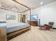 The main bedroom features a canopy bed, wood floors, and a TV at 3924 N Ridge Ave, Tampa, FL 33603