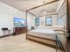 Spacious main bedroom with a canopy bed, chandelier, wood floors, and a large TV at 3924 N Ridge Ave, Tampa, FL 33603