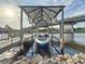 Boat in a covered dock; bridge provides a backdrop to the waterfront property at 3924 N Ridge Ave, Tampa, FL 33603