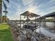 View of a boat in a covered dock on the water with a bridge in the background at 3924 N Ridge Ave, Tampa, FL 33603