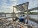 Private covered boat dock with a boat lift offers convenient waterfront access, a boater's dream at 3924 N Ridge Ave, Tampa, FL 33603