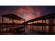 Picturesque waterfront scene showcasing a covered boat dock with a boat lift under a colorful sunset sky at 3924 N Ridge Ave, Tampa, FL 33603