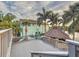 Scenic outdoor deck with palm trees, leading to a charming gazebo overlooking the water at 3924 N Ridge Ave, Tampa, FL 33603