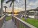 A beautiful walkway leading to the dock, complete with a gazebo and stunning sunset views at 3924 N Ridge Ave, Tampa, FL 33603